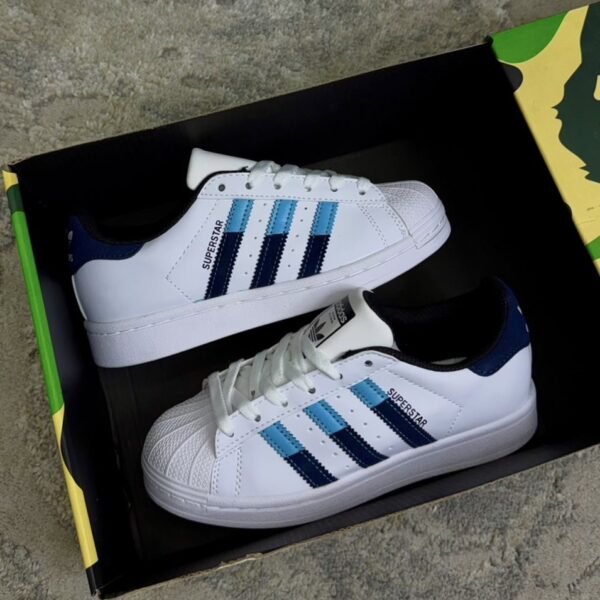 ADIDAS SUPERSTAR BLANCA CELESTE DAMA ADIDAS SUPERSTAR BLANCA CELESTE